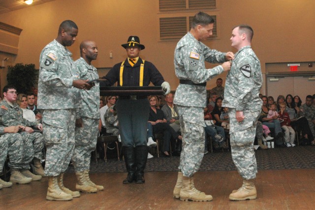 Sgt. 1st Class Matthew Mercado, of Company D, 2nd Battalion, 8th Cavalry Regiment, 1st Cavalry Division, receives his Purple Heart Medal from Brig. Gen. Frederick S. Rudesheim, installation commander from III Corps and Fort Hood, for wounds...