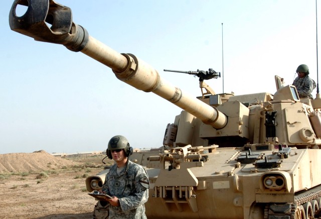 Marion, Ohio native Spc. James Davis (left), the number one man on a Battery A, 1st Battalion, 82nd Field Artillery Regiment M109A6 Paladin howitzer section crew, checks his manual calculations to ensure his crew fires "steel on target" as Sgt....