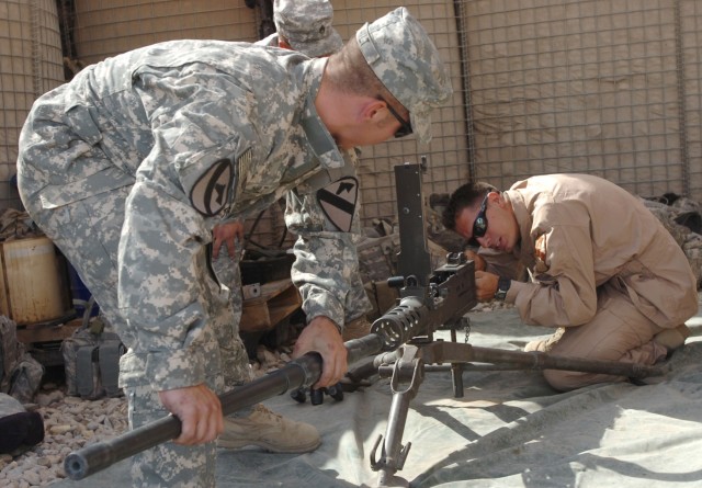 Springfield, Ohio native, Spc. Kenneth Hilt and Winston-Salem, N.C., native, Spc. Stephen Mondy, both M109A6 Paladin howitzer crew members with Battery B, 1st Battalion, 82nd Field Artillery Regiment, reassemble a .50 calibur machine gun during...