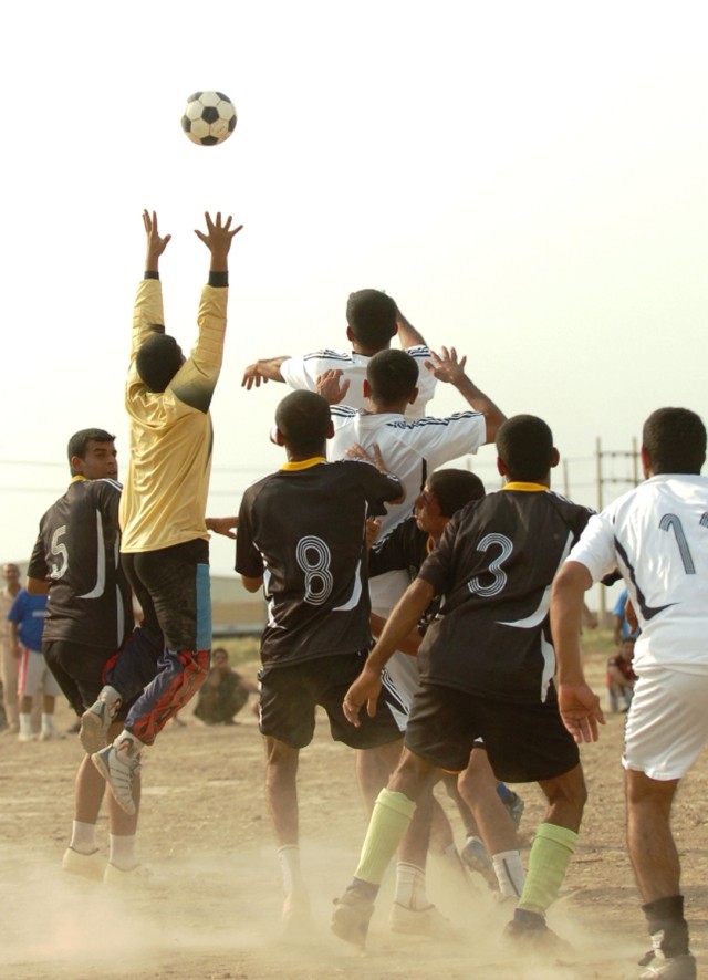 The goalie from the 2nd Battalion, 5th Brigade, 2nd National Police Division, goes up to catch the ball before the policemen from the 1st Battalion have a chance to score during the championship soccer game at the National Police Academy in...