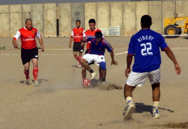 A member of the 2nd Battalion, 1st Brigade, 6th Division Iraqi Army's soccer team (in blue), tries to block the 1st Battalion, 5th Cavalry Regiment team from getting the soccer ball during a tournament at Camp Liberty, Oct. 28. The tournament was par...