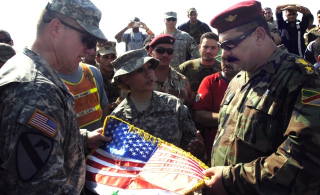 Huntsville, Ala., native, Lt. Col. Dale Kuehl, commander of the 1st Battalion, 5th Cavalry Regiment, presents Iraqi Army Lt. Col. Wail Mohamed Hussain, commander of the 2nd Battalion, 1st Brigade, 6th Division Iraqi Army, with a gift in appreciation ...