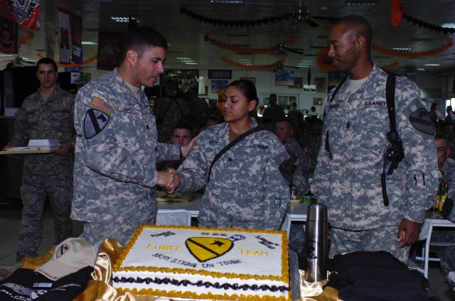 Killeen, Texas native Spc. Diana Mota (center), Headquarter Support Company, Division Special Troop Battalion, 1st Cavalry Division, is congratulated by her battalion commander, Lt. Col. Daniel R. García (left), and Command Sgt. Maj. Jeffery Moses, t...