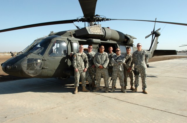 Soldiers from Company B "Avengers," 615th Aviation Support Battalion, 1st Air Cavalry Brigade, 1st Cavalry Division, pose near the UH-60 Black Hawk that they worked for their 200th major scheduled maintenance task - called a phase. A phase is when...