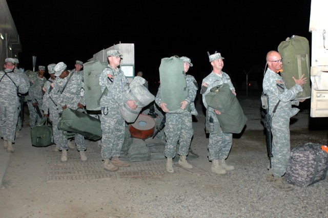 Soldiers from the 1st Air Cavalry "Warrior" Brigade, 1st Cavalry Division, load their bags up on a truck at Camp Taji, Iraq, before they begin their wait for their flight to head home Oct. 31. This group of troopers will set up the units' footprint i...