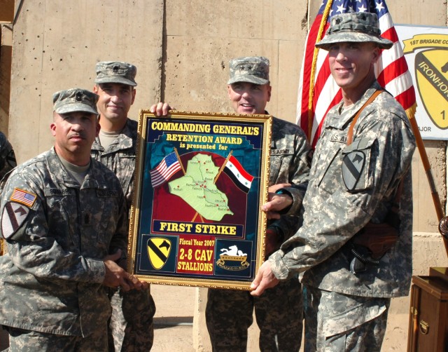 Command Sgt. Maj. Pablo Squiabro (left), senior noncommissioned officer for 2nd Battalion, 8th Cavalry Regiment, and Lt. Col. Scott Efflandt (right), commander, 2nd Bn., 8th Cav. Regt. receive the 1st Cavalry Division's battalion-level First Strike A...