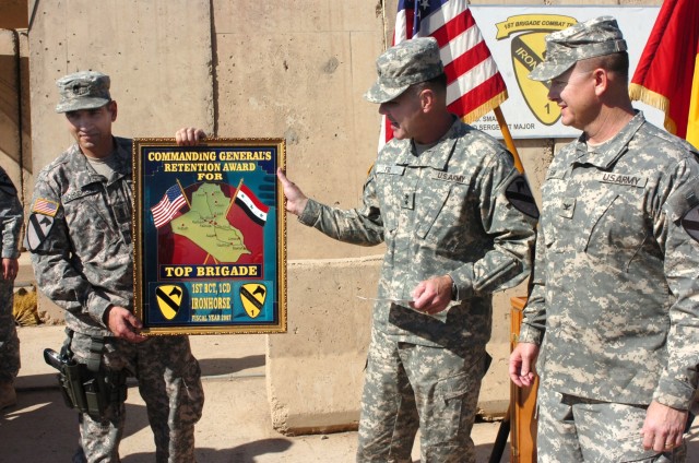 Maj. Gen. Joseph F. Fil (second from right), commanding general, Multi-National Division-Baghdad and 1st Cavalry Division, and Command Sgt. Maj. Philip F. Johndrow (left), MND-B command sergeant major, present the 1st Cavalry Division's top brigade f...