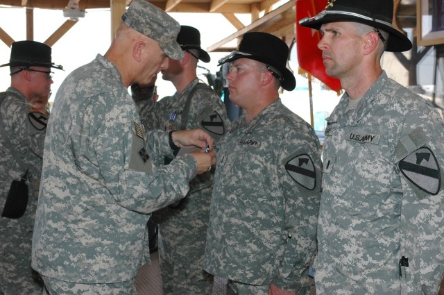 Lt. Gen. Raymond Odierno, commanding general of Multi-National Corps-Iraq, (left) presents the Distinguished Flying Cross to Onawa, Iowa, native Chief Warrant Officer Elliott Ham, (second from right), as Portage, Ind., native Chief Warrant Officer 4 ...