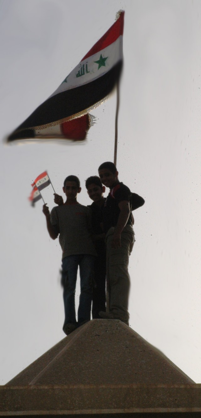 Iraqi boys from the Taji area of northwestern Baghdad stand atop the roof of the Sheik Support Center Nov. 8. The boys observed and listened to local tribal, government and military leaders discuss security, economic and essential service issues...