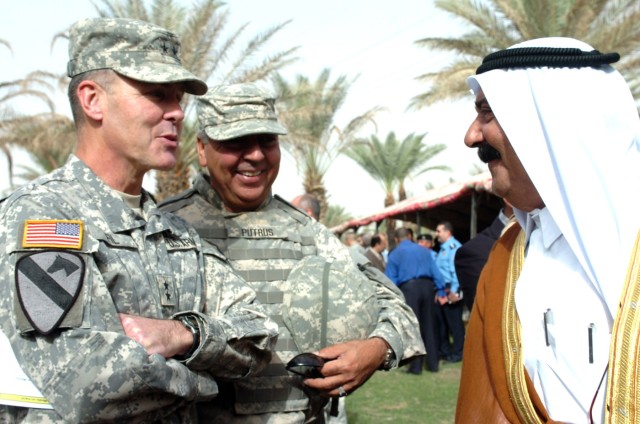 Maj. Gen. Joseph F. Fil Jr., commanding general of the Multi-National Division-Baghdad and 1st Cavalry Division, speaks to a local tribal sheik about the new step of establishing Iraq's self-sustainment during the Northwest Baghdad Regional Summit...
