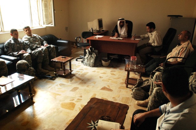 Members of the 1st Battalion, 5th Cavalry Regiment, a Fort Hood, Texas-based unit operating in western Baghdad attached to the 2nd Brigade Combat Team, 1st Infantry Division, discuss the future of the Ameriyah region of the Mansour District with loca...