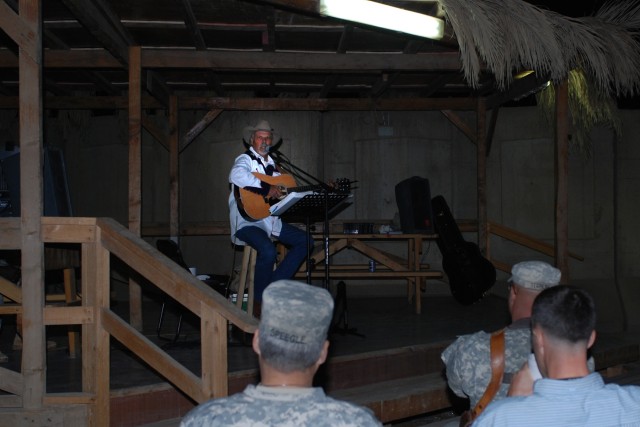 Soldiers listen in as Salado, Texas native, Freddie Fuller performs at the Pegasus Dining Facility at Camp Liberty in western Baghdad, Nov. 12. Fuller, who calls himself the "Singing Cowboy," performed the last of his seven-concert tour outside the 1...