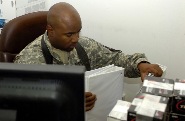 Philadelphia native, Spc. Jermaine Lawson, supply clerk with Company C, 2nd Battalion, 5th Cavalry Regiment packs up binders to send back home, Nov. 5 at Camp Liberty in western Baghdad. Lawson's company is attached to the 1st Cavalry Division Specia...