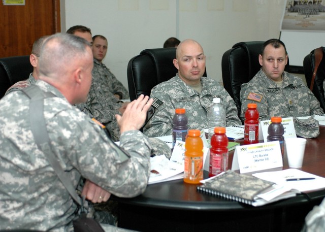 Kuna, Idaho, native Lt. Col. Cory Smith (right), the 1st Cavalry Division's aviation and airspace management officer, takes notes as Traverse City, Mich., native Col. Dan Shanahan (left), commander of the 1st Air Cavalry Brigade "Warriors," 1st...