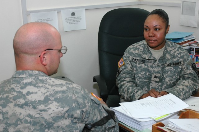 Sgt. Janeice Capers, (right), a Property Book Office clerk for 1st Air Cavalry Brigade, 1st Cavalry Division, speaks with Denton, Texas, native Sgt. Austin Sweet, 1st "Attack" Battalion, 227th Aviation Regiment, 1st ACB, Nov. 17 at Camp Taji,...