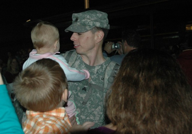 Lawrenceburg, Ky, native Sgt. Russell Neal, an apache mechanic with 4th Battalion, 227th Aviation Regiment, 1st Air Cavalry Brigade, 1st Cavalry Division, reunites with his family at a homecoming ceremony on Cooper Field at Fort Hood, Texas,...