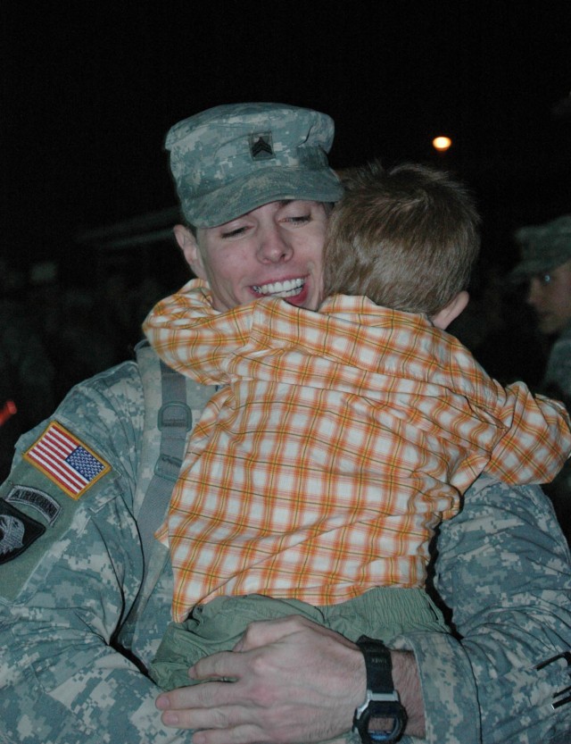 Lawrenceburg, Ky, native Sgt. Russell Neal, an apache mechanic with 4th Battalion, 227th Aviation Regiment, 1st Air Cavalry Brigade, 1st Cavalry Division, shares a hug with his 3-year-old son, Isaiah, at a homecoming ceremony on Cooper Field at...