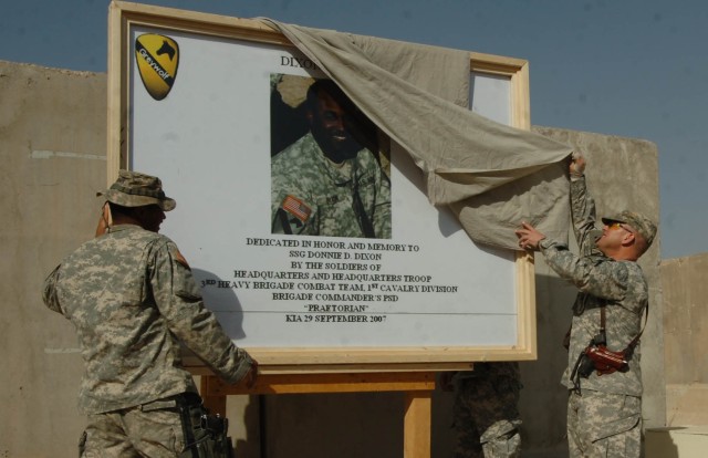 Col. David W. Sutherland, brigade commander of 3rd Brigade Combat Team, 1st Cavalry Division, and Staff Sgt. Mario Whitaker, non-commissioned officer in charge of Sutherland's personal security detachment, unveil the dedication sign of Dixon...