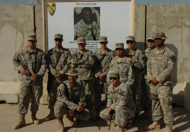 Members of the Personal Security Detachment, 3rd Brigade Combat Team, 1st Cavalry Division, stand in front of the picture of Staff Sgt. Donnie Dixon during the dedication ceremony of the Dixon Square, Nov. 22.  Dixon, who died of wounds received...
