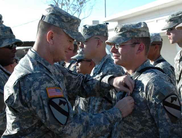 Col. Paul E. Funk II, commander, 1st "Ironhorse" Brigade Combat Team, 1st Cavalry Division, presents the Bronze Star Medal with "V" device for valor to Raymond, N.H., native Spc. Nathaniel Patterson of Company D, 2nd "Stallion" Battalion, 8th Cavalry...