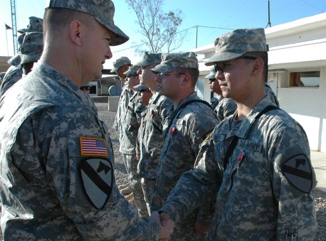 Col. Paul E. Funk II, commander, 1st "Ironhorse" Brigade Combat Team, 1st Cavalry Division shakes the hand of Marysville, Calif. native Spc. Pao Vang of Company D, 2nd "Stallion" Battalion, 8th Cavalry Regiment after presenting Vang with the Bronze S...