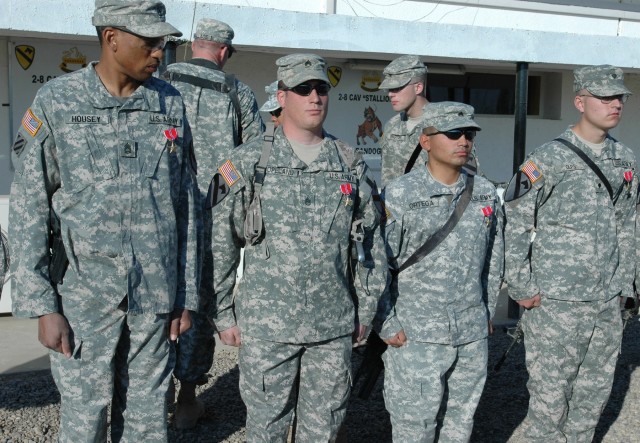 Soldiers from Company D, 2nd "Stallion" Battalion, 8th Cavalry Regiment stand near their company area after receiving the Bronze Star Medal with "V" device for valor during an award ceremony at Camp Taji, Iraq Nov. 23. The Soldiers received their awa...