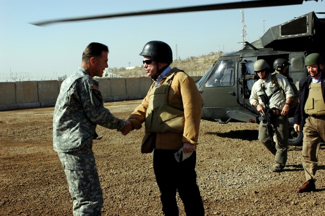 Maj. Gen. Joseph F. Fil, Jr., 1st Cavalry Division and Multi-National Division - Baghdad commanding general, greets Arizona Senator John McCain at the Pegasus Landing Zone at Camp Liberty in western Baghdad, Nov. 22. Fil escorted McCain and other...