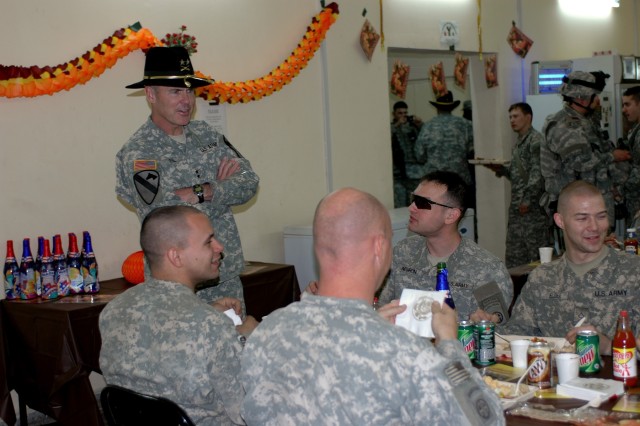 Maj. Gen. Joseph Fil, 1st Cavalry Division and Multi-National Division – Baghdad commanding general, visits with Soldiers at Coalition Outpost MOD in Baghdad, Nov. 22. Fil presented many of the Soldiers with the First Team’s ‘Live the...