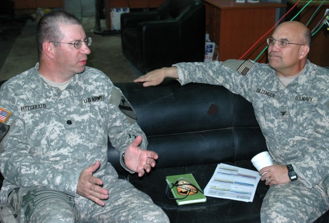 Lt. Col. Harvey Fitzgerald (left), senior agri-business advisor for the 1st "Ironhorse" Brigade Combat Team, 1st Cavalry Division's Embedded Provincial Reconstruction Team (EPRT Baghdad 5) and Navy Capt. John Dillender, economics and industrial advis...