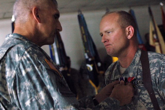 Maj. Gen. Mark P Hertling, commanding general of Multi-National Division-North and the 1st Armored Division, presents the Purple Heart to Col. David W. Sutherland, commander of the 3rd Brigade Combat Team, 1st Cavalry Division, after the brigade's...