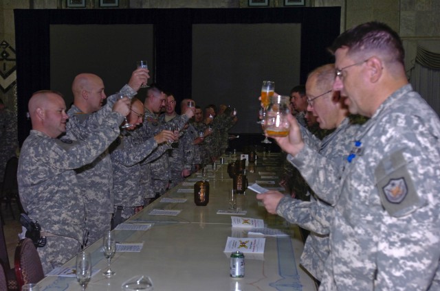 Soldiers of the 1st Cavalry Division and the 138th Fires Brigade, Kentucky Army National Guard, toast to the United States of America as part of the traditional St. Barbara induction ceremony in the Al-Faw Palace at Camp Victory in western...