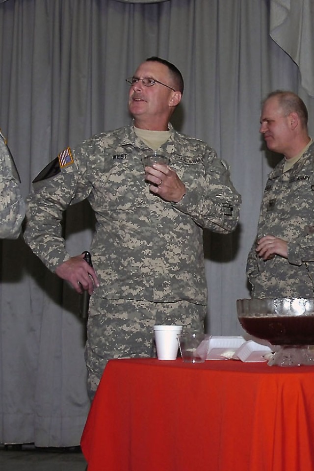 Richmond, Ky., native and co-host of the St. Barbara induction ceremony, Col. Billy Jack West, commander, 138th Field Artillery Brigade, Kentucky Army National Guard, tries the "artillery punch" to make sure it's fit for consumption for the...