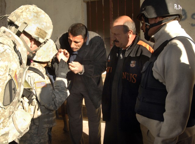 Hermosa, S.D., native Lt. Col. Harvey Fitzgerald (left), a senior agriculture business advisor for the Embedded 5 Provincial Team, attached to 1st Brigade Combat Team, 1st Cavalry Division, and Robert Dose (right), an Inma Agribusiness Program...