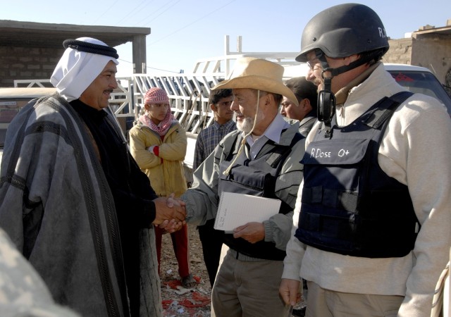 A local sheik meets with Edgar Ariza-Nino (center) and Robert Dose (right), Inma Agribusiness Program coordinators during a tour of the market in Taji, Iraq, Nov. 27.  The Inma program was established to stimulate and support agricultural business...