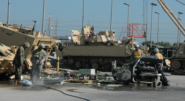 Soldiers from the 3rd Brigade Combat Team, 1st Cavalry Division, meticulously clean the brigade's combat equipment during the wash rack detail at Kuwait Naval Base, Nov. 30. Approximately 400 "Grey Wolf" Soldiers are working to meticulously clean...