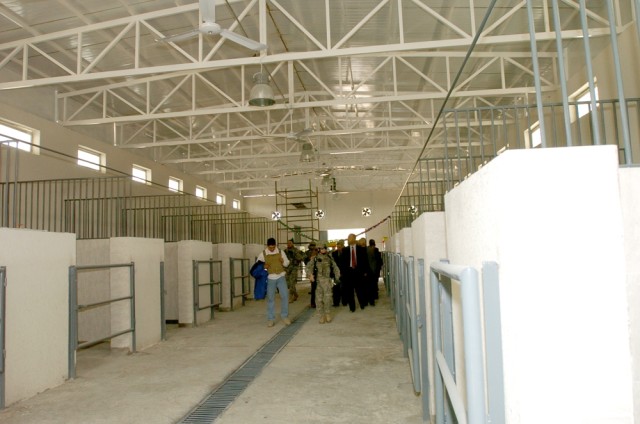 Carlisle, Pa., native Capt. Amy Cronin, the Special Projects officer for 15th Brigade Support Battalion, 2nd  Brigade Combat Team, 1st Cavalry Division, walks along with Baghdad Zoo and Zawra Park officials inside the horse stables during the Baghdad...