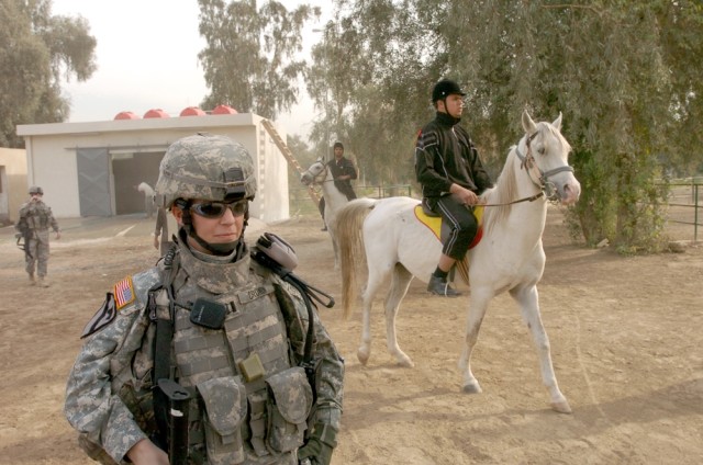Carlisle, Pa., native Capt. Amy Cronin, the special projects officer for the 15th Brigade Support Battalion, 2nd Brigade Combat Team, 1st Cavalry Division, walks along with an equestrian team during the Baghdad Zoo's new horse stables grand...