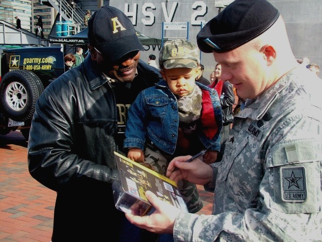 Sergeant hands out his own action figures at Army-Navy game