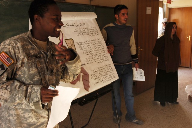 Sgt. Danielle Stephens, a preventive medicine specialist with Co. C, 15th BSB, 2nd BCT, 1st Cav. Div., talks about the importance of good oral hygiene during a presentation on health awareness to students at the Al Aflaph Elementary School in...