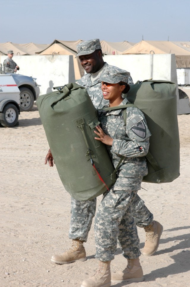 Even though she's carrying her own weight in baggage Brooklyn, N.Y., native Pfc. Milagros Escobar, a fueler for Company E, 1st "Attack" Battalion, 227th Aviation Regiment, 1st Air Cavalry Brigade, 1st Cavalry Division, laughs and smiles on her way to...
