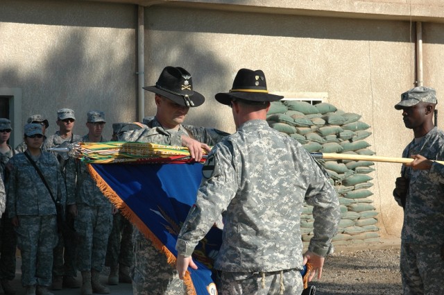 Lt. Col. Christopher Joslin, commander of 2nd "Lobo" Battalion, 227th Aviation Regiment, 1st Air Cavalry Brigade, 1st Cavalry Division, (left), and 1st Sgt. Terrance O'Neal, the acting battalion command sergeant major, (center), case the unit's...