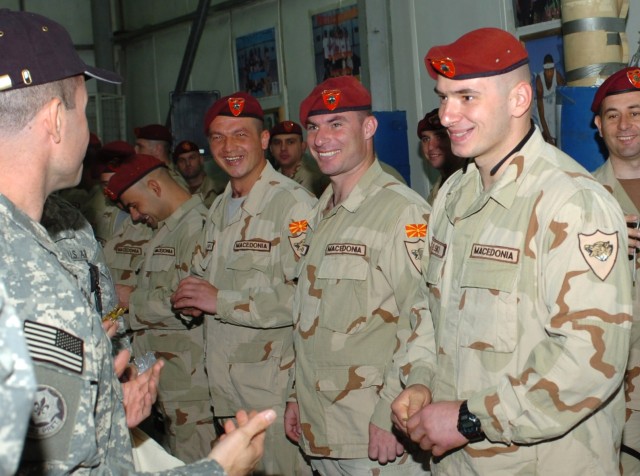 Sequim, Wash. native Lt. Col. Robert McAleer, commander, Fires Squadron, 2nd Stryker Cavalry Regiment, attached to the 1st "Ironhorse" Brigade Combat Team, 1st Cavalry Division, shares a joke while bidding farewell to Macedonian troops of the...