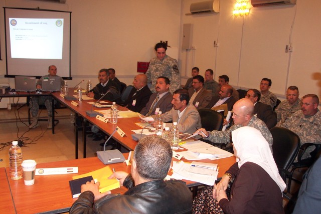 CAMP TAJI, Iraq -- Leadership from the Taji qada (a Baghdad rural district council) participates in the qada's first-ever Joint Rural Planning Committee meeting in Baghdad Dec. 12. Also pictured are senior leaders from the 1st "Ironhorse" Brigade...