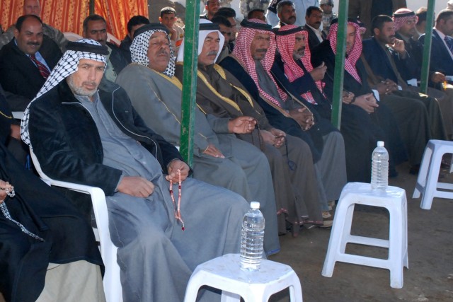 CAMP LIBERTY, Iraq - Local leaders in Aqur Quf, a town in the Abu Ghraib district near Baghdad, listen to key speakers outside the Iraqi Police station during a ceremony celebrating the reintegration of the Iraqi Police into the area on Dec. 12....