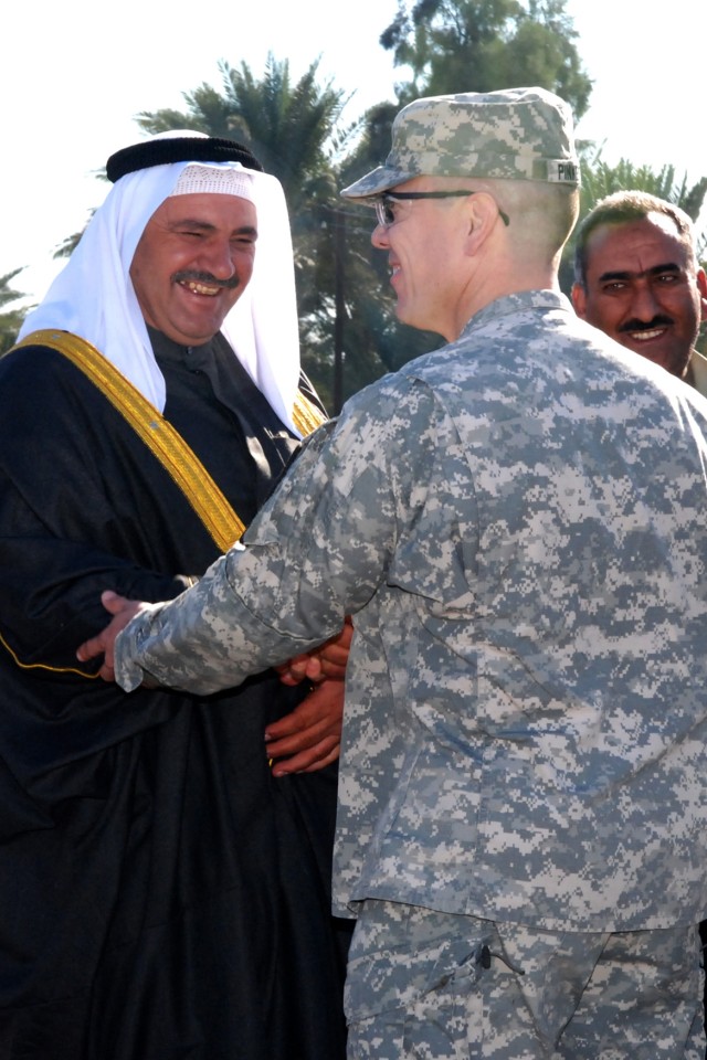 CAMP LIBERTY, Iraq – San Jose, Cal. native Lt. Col. Kurt J. Pinkerton, commander of the 2nd Squadron, 5th Cavalry Regiment, 1st Brigade Combat Team, 1st Cavalry Division, greets a local sheik before a ceremony at an Iraqi Police station in Aqur Quf, ...