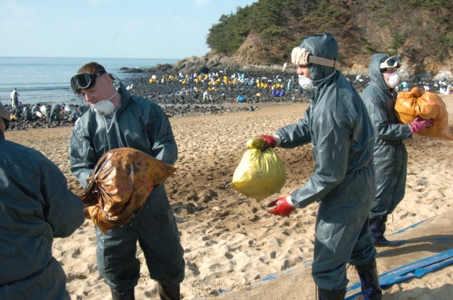 Human chain removes oil spill debris