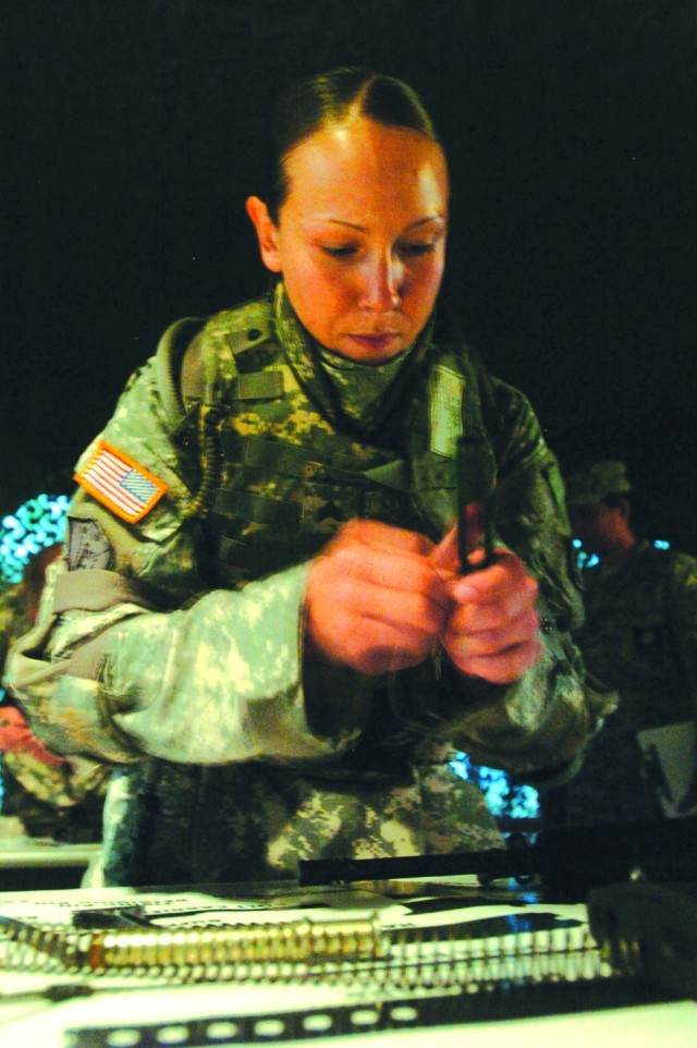 SPC Jamiell E. Goforth puts together an M16 rifle during the common tasks test.