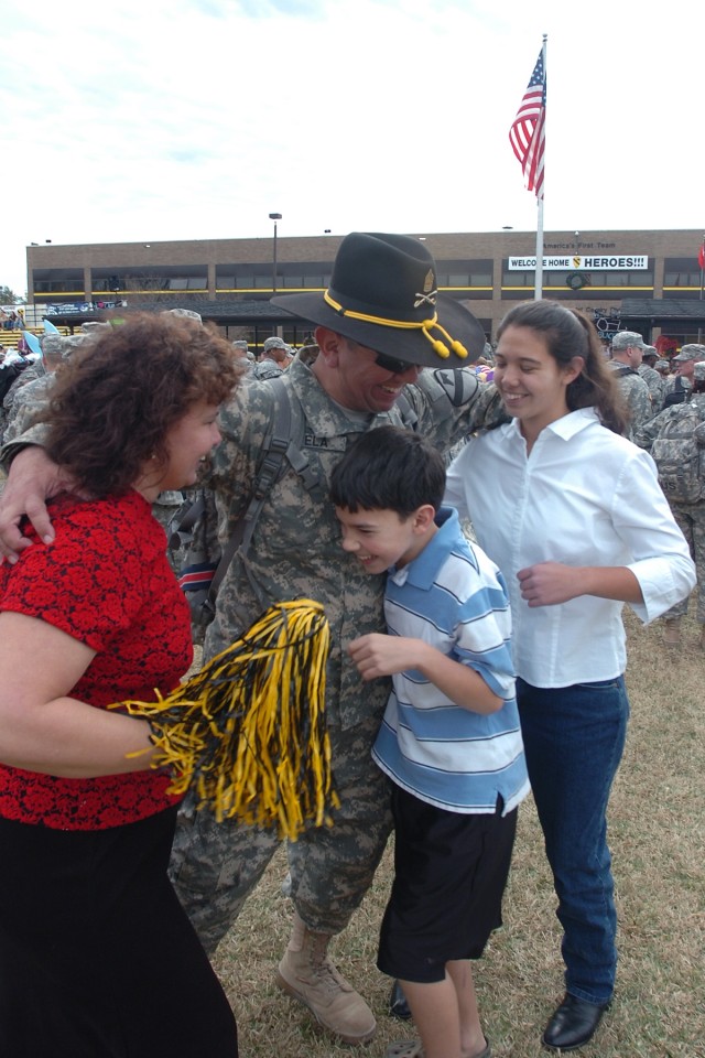 Dallas native Command Sgt. Maj. Glen Vela, the senior noncommissioned officer for the 615th Aviation Support Battalion, 1st Air Cavalry Brigade, 1st Cavalry Division, gives a great big hug to his wife Kathy (left) and his two kids Andy and Mindy duri...