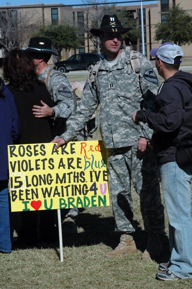 Capt. Braden Camp, with 1st Air Cavalry Brigade, hold a sign that was given to him during a homecoming ceremony in front of 1st Cavalry Division headquarters building on Cooper Field. Camp is one of more than 200 Soldiers who arrived home from Iraq D...
