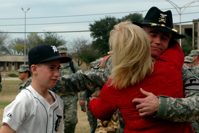 Traverse City, Mich., native Col. Daniel Shanahan, the 1st Air Cavalry Brigade commander, hugs his wife, Mindy, and reaches out for his oldest son, Patrick during the homecoming ceremony held Dec. 21 at 1st Cavalry Division headquarters. Shanahan was...